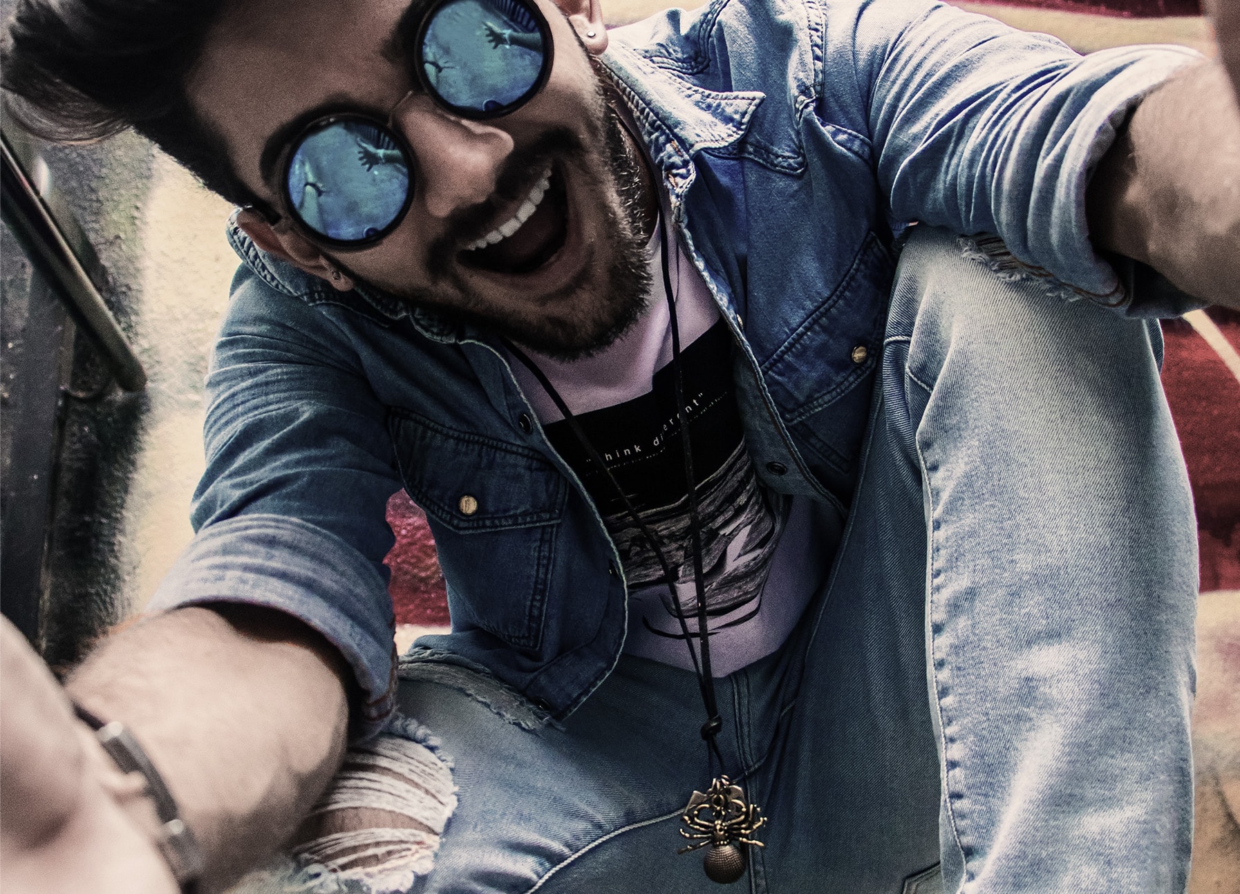 A person taking a selfie with sunglasses on